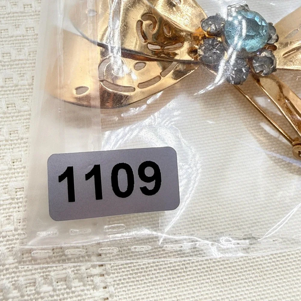 Vintage CORO Gray and Blue Rhinestones Gold Tone Cutout Bow Pin Brooch